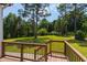 A sprawling backyard with mature trees viewed from the wood patio of this new construction home at 8621 Bishop Pine Ln, Wake Forest, NC 27587