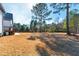 Expansive backyard with lush lawn, mature trees, and a glimpse of the home's rear exterior at 8621 Bishop Pine Ln, Wake Forest, NC 27587