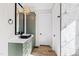 Bathroom with a vessel sink, olive green cabinets, and wood flooring at 8621 Bishop Pine Ln, Wake Forest, NC 27587