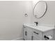 Bathroom features a white vanity, black hardware and round mirror at 8621 Bishop Pine Ln, Wake Forest, NC 27587