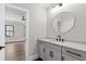 Bathroom with quartz counters, grey cabinets, and a round mirror at 8621 Bishop Pine Ln, Wake Forest, NC 27587