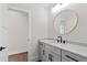 Bathroom with quartz counters, grey cabinets, and a round mirror at 8621 Bishop Pine Ln, Wake Forest, NC 27587