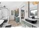 A well-lit bathroom features a glass shower, freestanding tub, dual sinks, and sleek modern fixtures at 8621 Bishop Pine Ln, Wake Forest, NC 27587