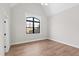 Bedroom features hardwood floors, vaulted ceiling, and a large arched window at 8621 Bishop Pine Ln, Wake Forest, NC 27587