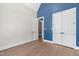Bedroom featuring tall ceilings, blue accent wall, and an en suite at 8621 Bishop Pine Ln, Wake Forest, NC 27587