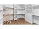 Spacious walk-in closet with custom built-in shelving and drawers at 8621 Bishop Pine Ln, Wake Forest, NC 27587
