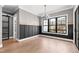 The dining room features wood floors, modern wainscotting, a designer light fixture, and natural light at 8621 Bishop Pine Ln, Wake Forest, NC 27587