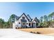 Beautiful two-story house featuring an elegant exterior, a driveway, manicured lawn, and lush greenery at 8621 Bishop Pine Ln, Wake Forest, NC 27587