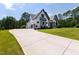 New construction home with long driveway on a well-manicured lawn at 8621 Bishop Pine Ln, Wake Forest, NC 27587