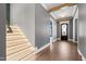 Elegant foyer with illuminated stairs, hardwood floors, and an arched doorway with glass at 8621 Bishop Pine Ln, Wake Forest, NC 27587