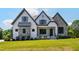 Beautiful new construction home with a manicured lawn, stone accents, and a welcoming front porch at 8621 Bishop Pine Ln, Wake Forest, NC 27587