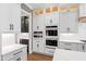This kitchen features white cabinets and stainless steel appliances and double ovens at 8621 Bishop Pine Ln, Wake Forest, NC 27587