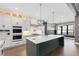 Bright kitchen with a large island, marble countertops, custom cabinets, and stainless appliances at 8621 Bishop Pine Ln, Wake Forest, NC 27587