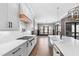 The kitchen features a professional range, farmhouse sink, custom cabinets, and designer lighting at 8621 Bishop Pine Ln, Wake Forest, NC 27587