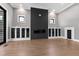 Modern living room featuring a sleek fireplace, built-in cabinets, and recessed lighting at 8621 Bishop Pine Ln, Wake Forest, NC 27587