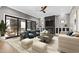 Inviting living room featuring a fireplace, modern furniture, and a seamless indoor-outdoor flow to the patio at 8621 Bishop Pine Ln, Wake Forest, NC 27587