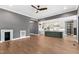 Bright living room showcasing hardwood floors, grey walls and open kitchen with modern island at 8621 Bishop Pine Ln, Wake Forest, NC 27587