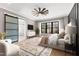 Inviting bedroom with a decorative rug, large windows, and a view of the outside at 8621 Bishop Pine Ln, Wake Forest, NC 27587