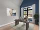 Home office with large window, modern desk, decor art and plenty of natural light at 8621 Bishop Pine Ln, Wake Forest, NC 27587