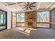 Enclosed porch featuring a stone fireplace, a ceiling fan, and a wood deck with views to the outside at 8621 Bishop Pine Ln, Wake Forest, NC 27587