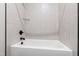 Bathtub and shower features modern hardware and decorative light-colored tile at 8621 Bishop Pine Ln, Wake Forest, NC 27587