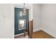 Staircase featuring modern railings and statement light fixture at 8621 Bishop Pine Ln, Wake Forest, NC 27587