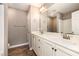 A full bathroom with double sinks, a large vanity, and modern lighting fixtures at 107 Rollingwood Cir, Kenly, NC 27542