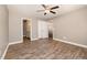 A neutral bedroom with hardwood floors, two closets, and a ceiling fan at 107 Rollingwood Cir, Kenly, NC 27542