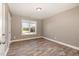 This is a bedroom with hardwood floors, neutral paint, and lots of natural light from the backyard at 107 Rollingwood Cir, Kenly, NC 27542