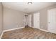 Empty bedroom with hardwood floors, neutral walls, and a closet, ready for your personal touch at 107 Rollingwood Cir, Kenly, NC 27542