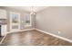 A bright dining room with hardwood floors, a backyard view, and neutral paint at 107 Rollingwood Cir, Kenly, NC 27542