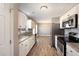 A bright kitchen with stainless steel appliances, granite countertops, and white cabinets at 107 Rollingwood Cir, Kenly, NC 27542