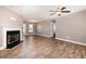 Bright living room with wood floors, a decorative fireplace, and an open layout at 107 Rollingwood Cir, Kenly, NC 27542
