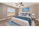 A well-decorated main bedroom with hardwood floors, a ceiling fan, and a backyard view at 107 Rollingwood Cir, Kenly, NC 27542