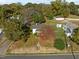 Aerial view of a cozy home with a red-leafed tree in the yard at 110 W Elm St, Nashville, NC 27856