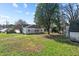 Spacious backyard featuring mature trees and a shed in a private setting at 110 W Elm St, Nashville, NC 27856