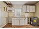 Image of the kitchen area featuring cabinets, sink, and window at 110 W Elm St, Nashville, NC 27856