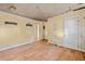 Living room features wood-look flooring, neutral walls, and multiple doorways, ready for renovation at 110 W Elm St, Nashville, NC 27856