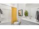 Well-lit bathroom featuring a shower/tub combo with a yellow curtain and a modern vanity with a fern at 129 Ethel Ln, Angier, NC 27501
