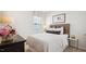Cozy bedroom displaying a bed with decorative pillows and a window with white and gray patterned shades at 129 Ethel Ln, Angier, NC 27501