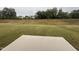 Expansive backyard with grass leading to a treeline, houses visible in the distance at 139 Ethel Ln, Angier, NC 27501
