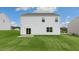 A level backyard features new grass, a small patio, and a white siding home at 139 Ethel Ln, Angier, NC 27501