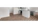 Bright kitchen featuring stainless appliances, gray cabinetry, wood floors and a granite island countertop at 139 Ethel Ln, Angier, NC 27501