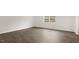 Spacious living room featuring hardwood flooring and a large window overlooking the exterior at 139 Ethel Ln, Angier, NC 27501