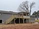 A new construction view of a house with a large back porch and stairs to the yard at 1516 Bragg St, Sanford, NC 27330