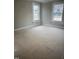 Bright bedroom featuring unfinished floors, new drywall, and windows, ready for customization at 1516 Bragg St, Sanford, NC 27330