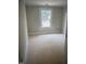 Unfinished bedroom displaying new drywall, trim, and a double-hung window with natural light at 1516 Bragg St, Sanford, NC 27330