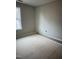 Bedroom featuring a window with natural lighting and unfinished flooring at 1516 Bragg St, Sanford, NC 27330
