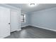A bedroom with wood-look floors and an open closet door at 1729 Augustus Dr, Rocky Mount, NC 27801