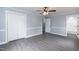 Bedroom with neutral paint, gray floors, closet and view to an attached bathroom at 1729 Augustus Dr, Rocky Mount, NC 27801